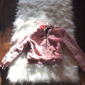 A soft pink jacket with flower detailing inside🌸